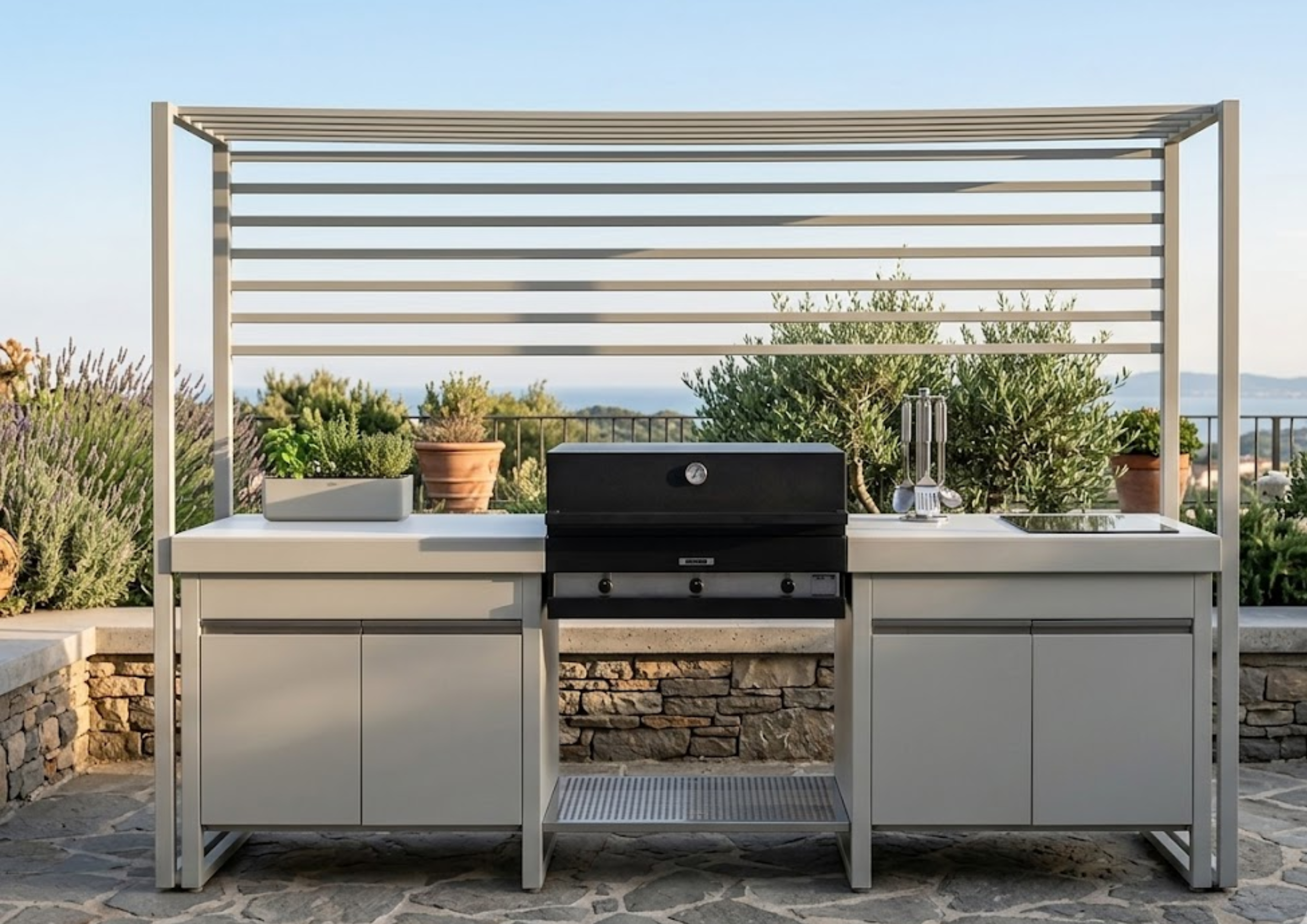 Cocina de exterior Lares de FÒGHER con estructura de acero, barbacoa integrada y encimera de trabajo en jardín