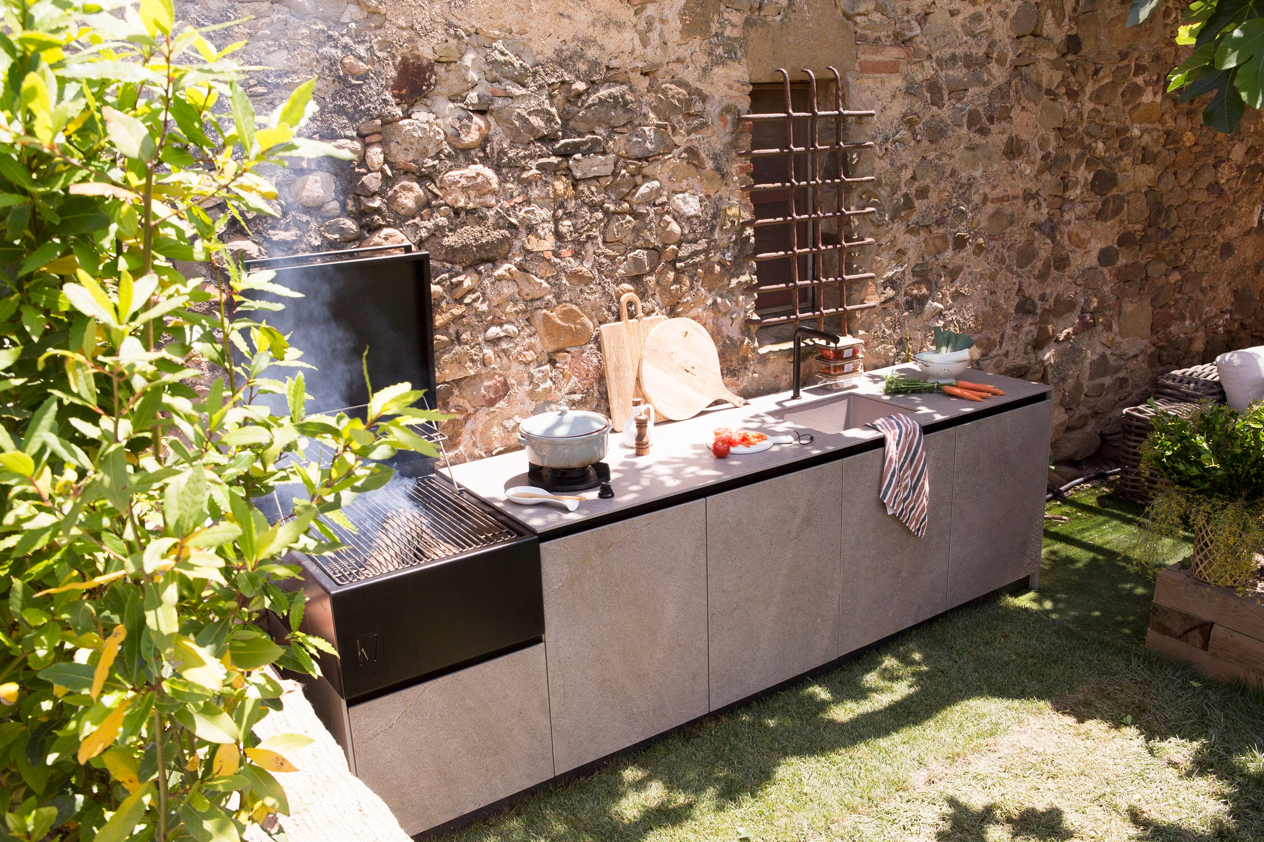 Vista de la cocina Rekker K7 en uso durante una comida al aire libre, destacando su amplia superficie de trabajo y ergonomía.